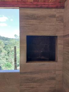 a fireplace in a wall with a window at Chale Primavera in Benedito Novo