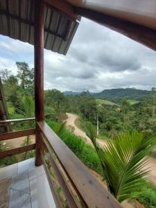 a view from the balcony of a house with a dirt road at Chale Primavera in Benedito Novo