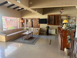 a living room with a couch and a table at Hotel Ideal vcp in Villa Carlos Paz