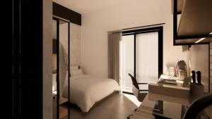 a bedroom with a bed and a desk with a mirror at Voyager Residence in Semarang