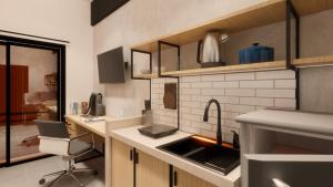 a kitchen with a sink and a desk at Voyager Residence in Semarang