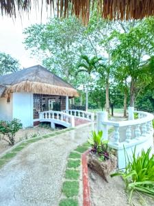 a small building with a bridge in front of it at Anaya Villas Resort in Bantayan Island
