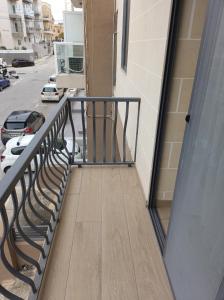 a balcony with a railing and a parking lot at Sandstone Residence St Julian's - 2 bedrooms in Is-Swieqi