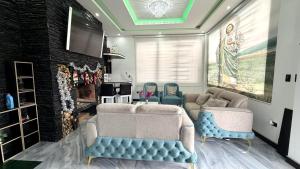 a living room with two couches and a tv at Quinta Nallig in Gualaceo