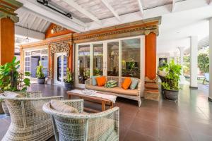 an outdoor living room with a couch and chairs at Alinta Villa 1 - Spacious Sanctuary in Sanur