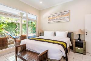 a bedroom with a large bed and a window at Alinta Villa 1 - Spacious Sanctuary in Sanur +12 photos