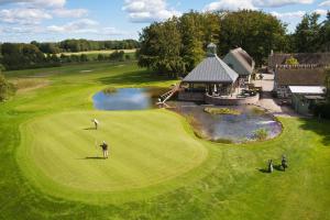 - une vue aérienne sur un parcours de golf avec un homme jouant au golf dans l'établissement Araslöv Golf & Resort, à Kristianstad
