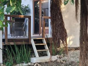 a ladder leading up to a window on a porch at Villa Rose Barth Location de Chambre in Saint-Louis +2 photos
