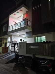 two motorcycles parked in front of a building at night at Avs Jain's house in Ujjain