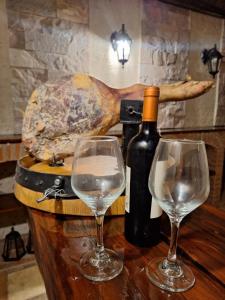 a bottle of wine and two wine glasses on a table at Etel in San Rafael