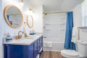 a bathroom with a blue sink and a mirror at Renovated Retreat Home in Huron, close to beaches in Huron +16 photos