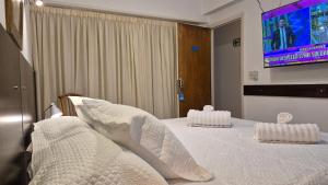 En eller flere senge i et værelse på Continental Hotel