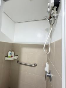 a shower in a bathroom with a shower head at 1 Bedroom Condo Unit at Centrio Tower in Cagayan de Oro +15 photos
