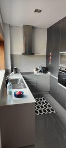 a kitchen with a sink and a counter top at Furadouro pine beach apartment in Ovar