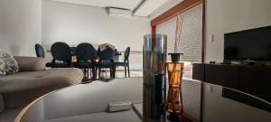 a living room with a couch and a table with chairs at Furadouro pine beach apartment in Ovar