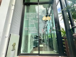 a window of a restaurant with a sign in it at Pure Laguna Residence by Nice Sea Resort in Srithanu +33 photos