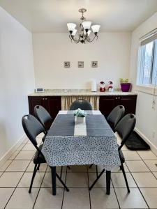 a dining room with a table and chairs at Cozy Full House 3 bedrooms in Regina