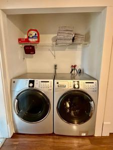a washer and dryer in a laundry room at Cozy Full House 3 bedrooms in Regina