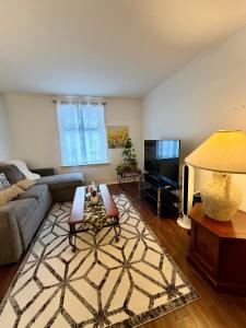a living room with a couch and a table at Cozy Full House 3 bedrooms in Regina
