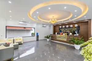 a lobby with a reception desk and a large ceiling at Ruby Mountain View Resort Vang-vieng in Vang Vieng