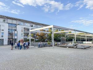 a group of people walking in front of a building at City Apartments Gerlingen in Gerlingen