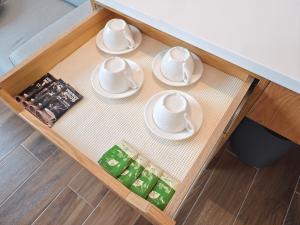 a table with four cups and saucers on it at Hanpin Homestay in Yuli +24 photos