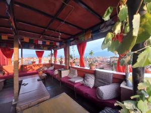 a bar with red couches and a view of the city at Swastik Guest House in Bhaktapur