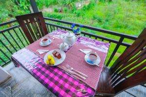 a table with a plate of food on top at Forest Edge Villa in Ella