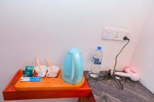 a blue blender sitting on a wooden table at Forest Edge Villa in Ella
