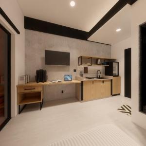 a room with a kitchen with a desk and a tv at Voyager Residence in Semarang