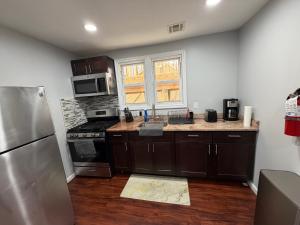 a kitchen with a sink and a stove top oven at JD Apartment and House in Seaside Heights +20 photos