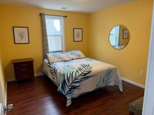 a bedroom with a bed and a mirror at JD Apartment and House in Seaside Heights