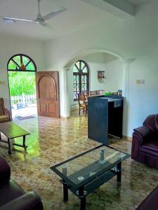 a living room with a couch and a table at Diyakalana Rest in Ginigathena