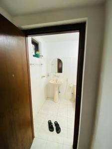 a bathroom with a shower and a sink and shoes at Open Sky Villa in Hikkaduwa