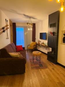 a living room with a couch and a table at Winter Park Residence Bjelasnica in Bjelašnica