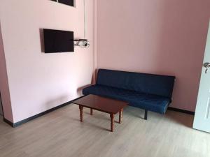 a blue couch in a room with a coffee table at Dongorit Cabin 2 The three rooms in Kampong Kundassan