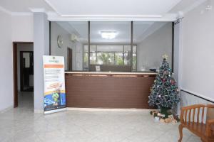 a christmas tree in the lobby of a restaurant at Mekarsari Hotel By ARBA in Tjipitjung Tiga