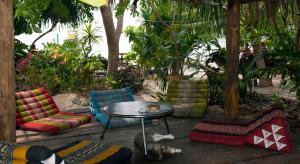 a patio with colorful chairs and a table at Sunflower Boathouse in Phi Phi Islands