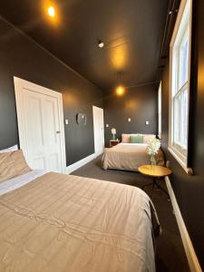 a bedroom with two beds and a table and a window at Rehutai in Wairoa