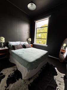 a bedroom with a large bed with a window at Rehutai in Wairoa