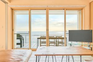 a room with a table and a view of the ocean at Villa Acatella in Awaji
