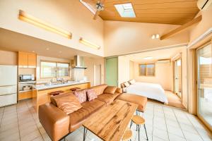 a living room with a couch and a bed at Villa Acatella in Awaji