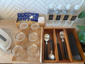 a wooden tray with utensils and bottles of water at Matsumoto 101 in Matsumoto +86 photos