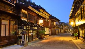 an empty street in an old town at night at Matsumoto 101 in Matsumoto