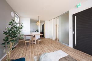 a living room with a table and a dining room at Matsumoto 101 in Matsumoto