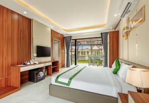 a bedroom with a large bed and a television at Ruby Mountain View Resort Vang-vieng in Vang Vieng
