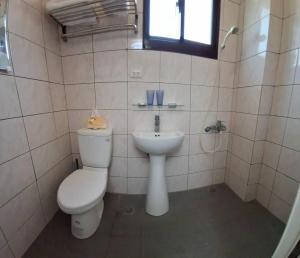 a bathroom with a toilet and a sink at Kinmen Dongshan B&B in Jinning