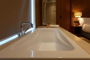 a large white kitchen sink in a room at Sukavi in Paravūr