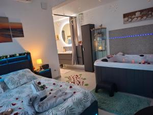 a bedroom with a tub and a bed and a bathroom at escapade coeur provence in La Celle