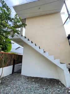 a stairway leading up to a house at Cardo Rooms 2 minutes walk from the beach in General Luna